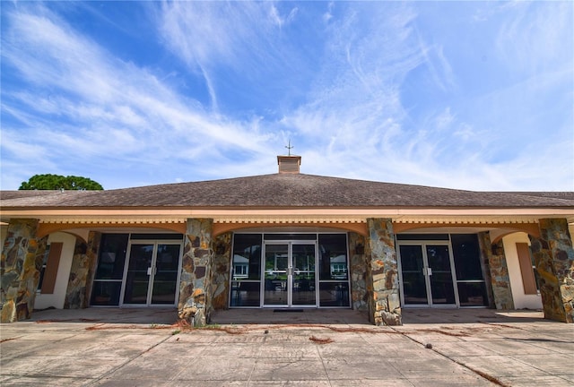 back of house with french doors and a patio