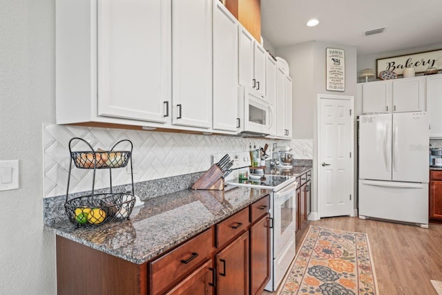 kitchen featuring white appliances, light hardwood / wood-style flooring, white cabinetry, and stone countertops