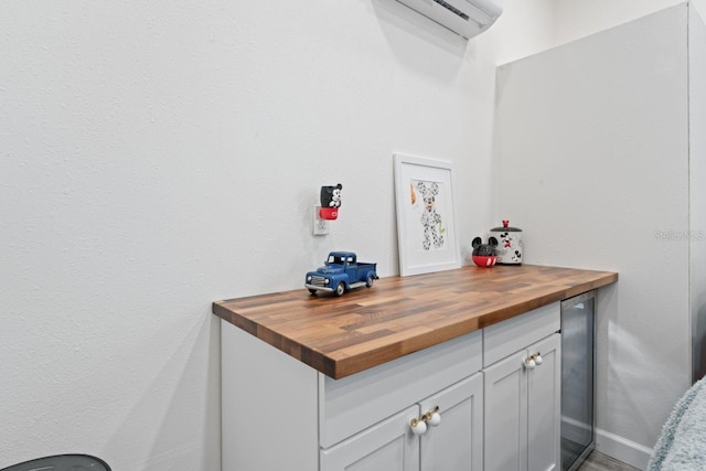 interior space featuring an AC wall unit and butcher block countertops