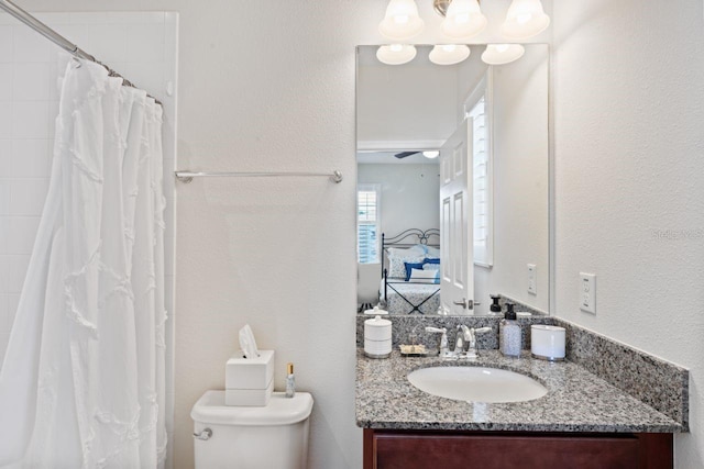 bathroom with toilet, a shower with curtain, and vanity