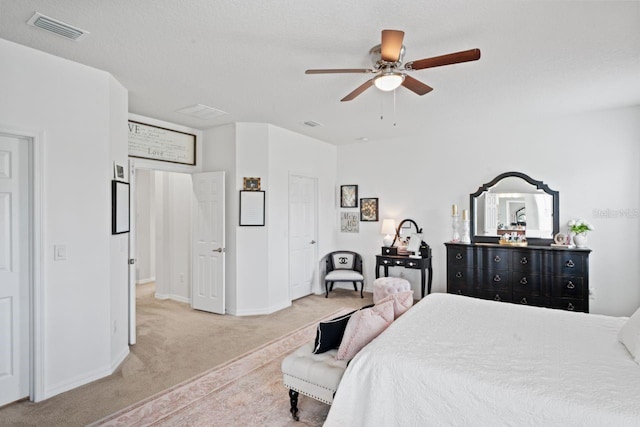 bedroom featuring carpet flooring, a textured ceiling, and ceiling fan