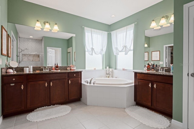 bathroom featuring shower with separate bathtub, vanity, and tile patterned flooring