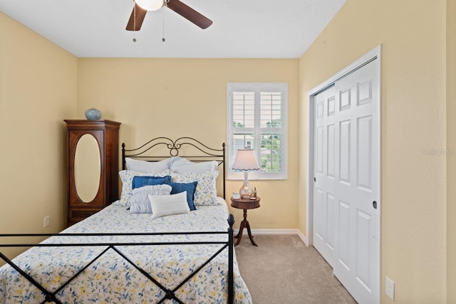 bedroom featuring ceiling fan, a closet, and carpet floors