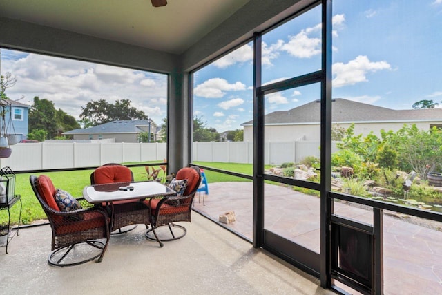 sunroom featuring ceiling fan