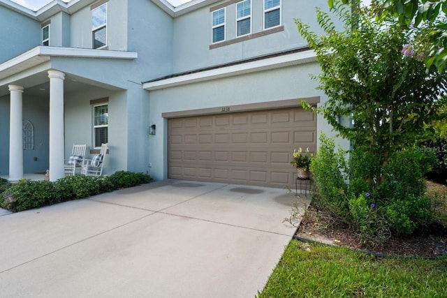 view of front of property featuring a garage and covered porch