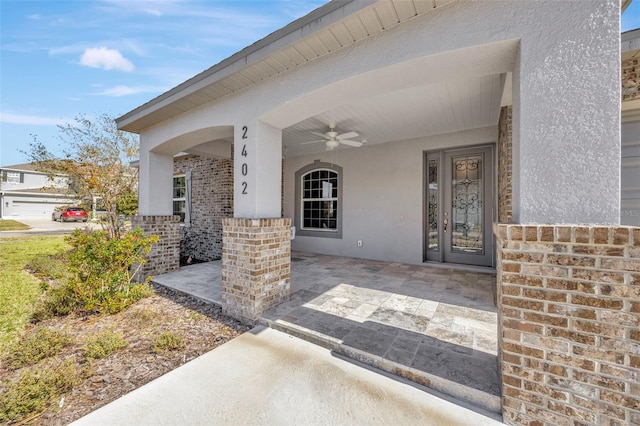 view of exterior entry with a patio and ceiling fan