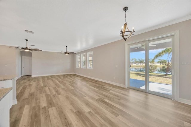 unfurnished living room with crown molding, light hardwood / wood-style flooring, ceiling fan with notable chandelier, and a water view