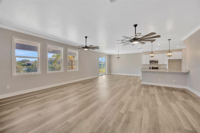 unfurnished living room with crown molding, ceiling fan with notable chandelier, a textured ceiling, and light hardwood / wood-style flooring