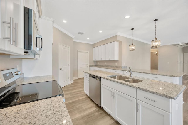 kitchen featuring white cabinetry, appliances with stainless steel finishes, a kitchen island with sink, and sink