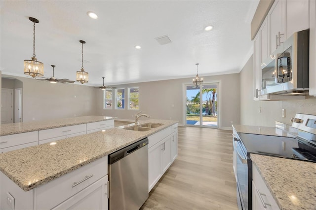 kitchen featuring sink, white cabinetry, stainless steel appliances, and a kitchen island with sink