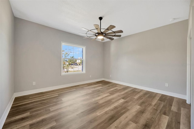 empty room with ceiling fan and hardwood / wood-style floors