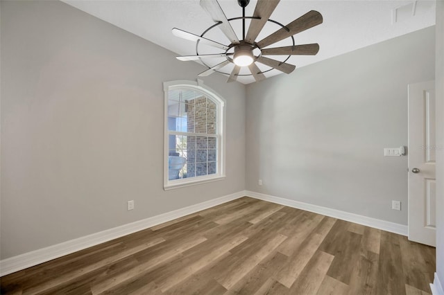 spare room with wood-type flooring and ceiling fan