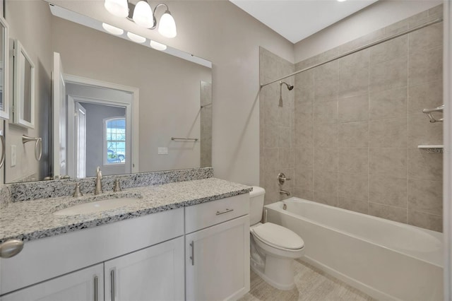 full bathroom with vanity, toilet, and tiled shower / bath