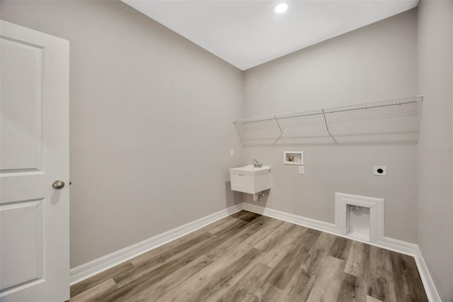 washroom featuring sink, washer hookup, hookup for an electric dryer, and hardwood / wood-style floors