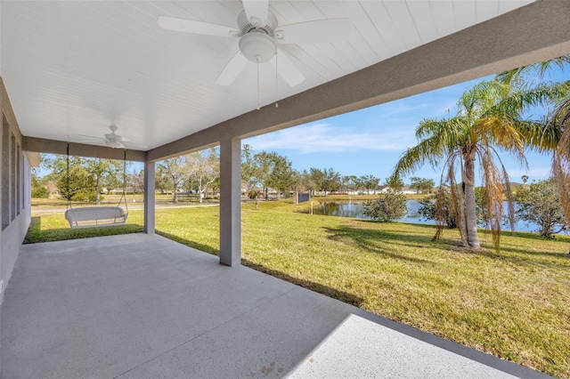 view of patio with ceiling fan and a water view