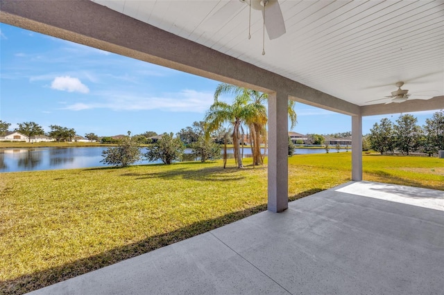 view of patio featuring a water view and ceiling fan