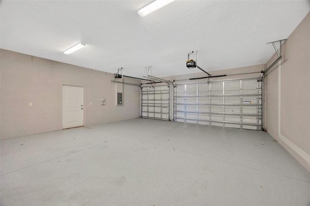 garage with a garage door opener and electric panel