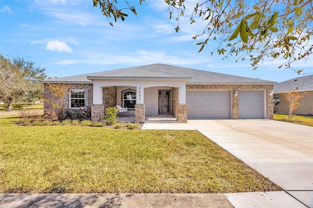 view of front of property featuring a garage, a front yard, and covered porch