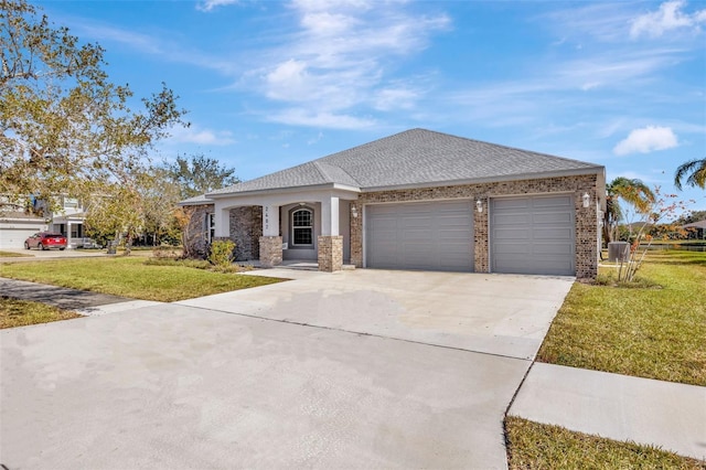 view of front of property featuring a garage, central AC unit, and a front lawn