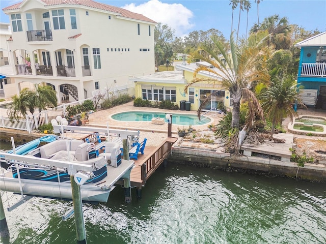 back of property with a patio area and a water view