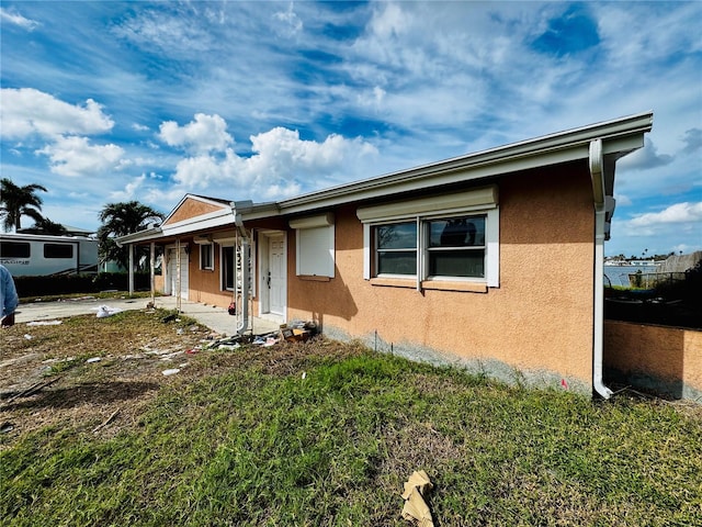 view of property exterior with a yard