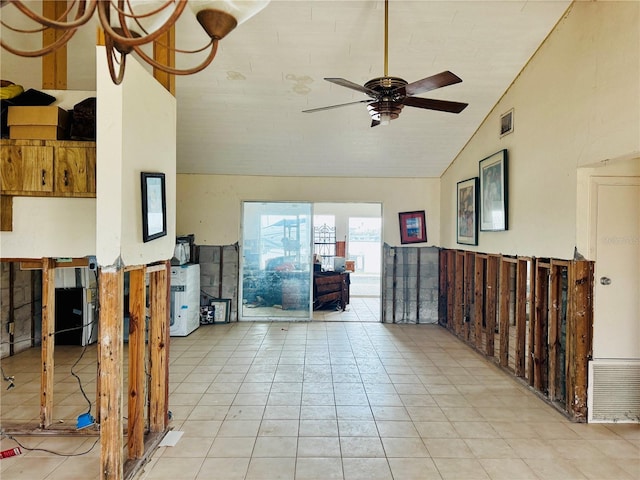 interior space featuring ceiling fan, light tile patterned floors, and high vaulted ceiling