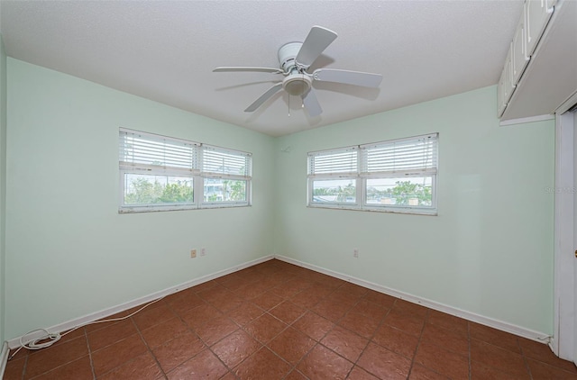 empty room featuring a textured ceiling and ceiling fan