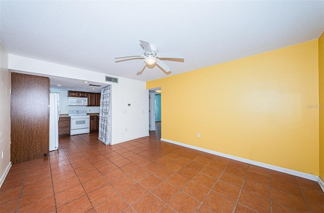 interior space with tile patterned flooring and ceiling fan