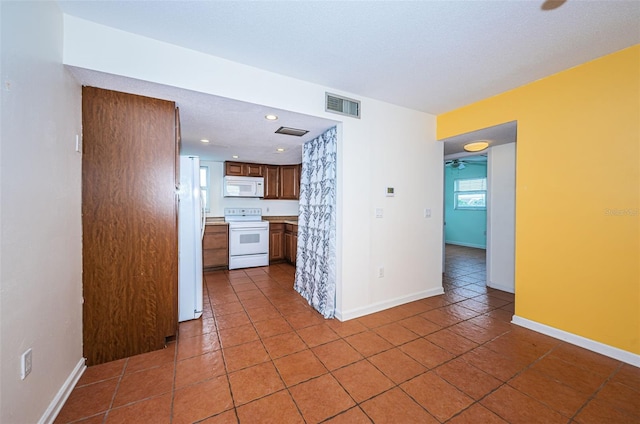 kitchen with white appliances and tile patterned flooring