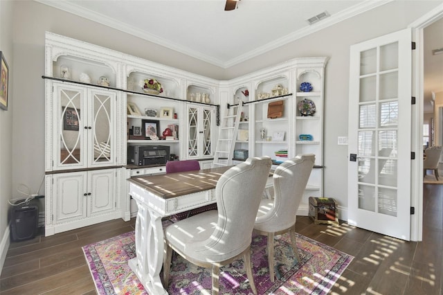 dining room featuring ornamental molding and dark hardwood / wood-style floors