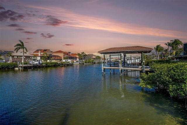 dock area featuring a water view, a residential view, and boat lift