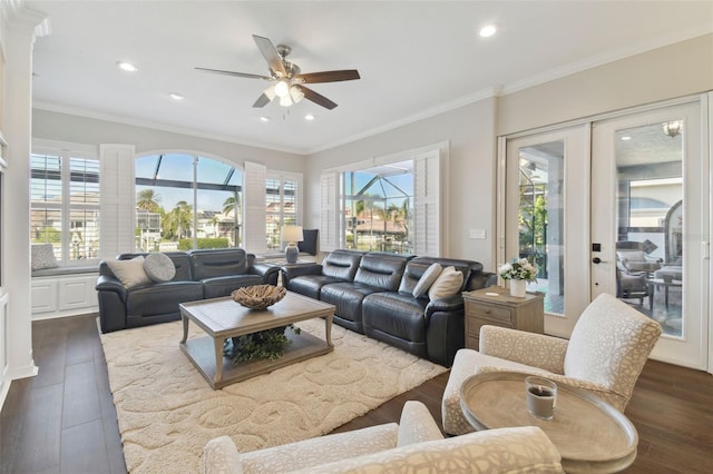 living room with crown molding, dark wood-type flooring, french doors, and ceiling fan