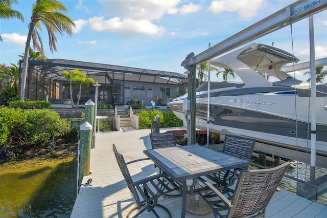 view of dock featuring glass enclosure and boat lift