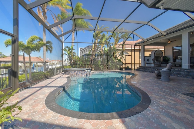 view of pool featuring an in ground hot tub, a lanai, and a patio area