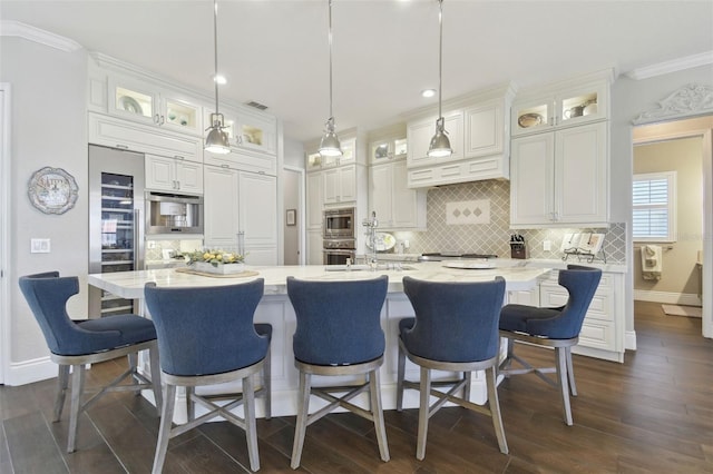 kitchen with white cabinetry, backsplash, dark wood-style flooring, and appliances with stainless steel finishes