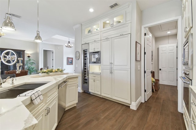 kitchen with pendant lighting, light stone countertops, white cabinets, and stainless steel appliances