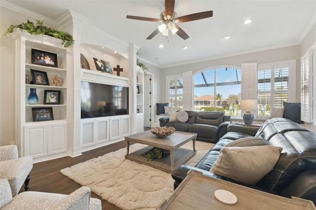 living room featuring plenty of natural light, wood finished floors, and crown molding