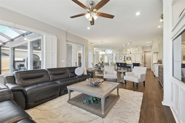 living room featuring dark wood finished floors, french doors, crown molding, and a ceiling fan