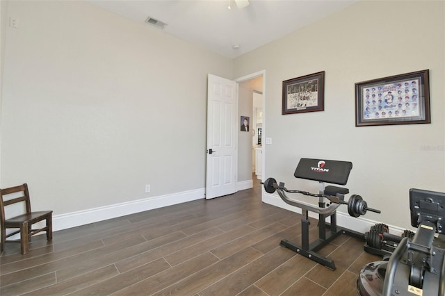 workout room featuring wood finish floors, visible vents, baseboards, and ceiling fan