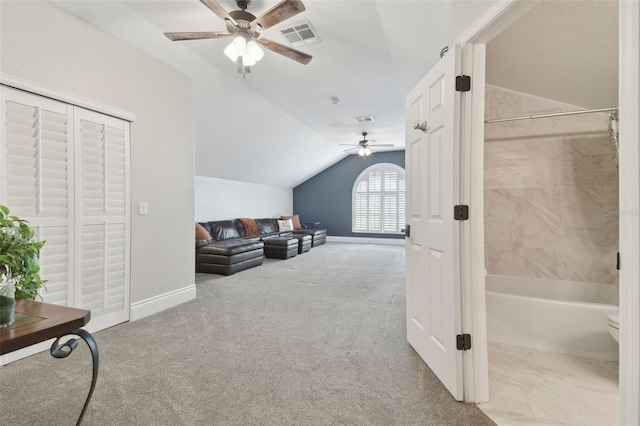 interior space with lofted ceiling, light colored carpet, and ceiling fan