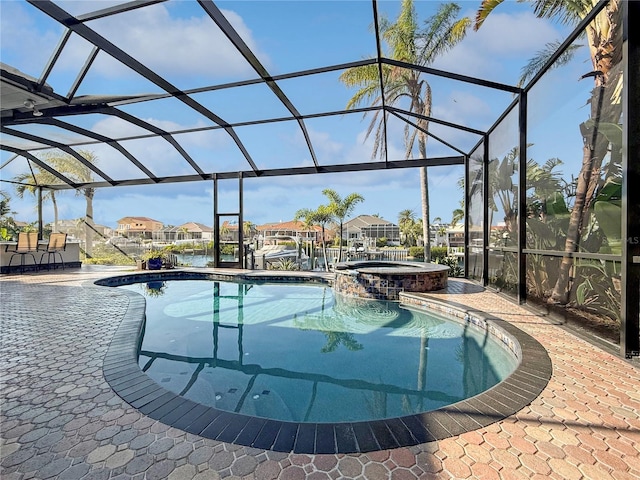 view of pool with a patio area, a residential view, glass enclosure, and a pool with connected hot tub