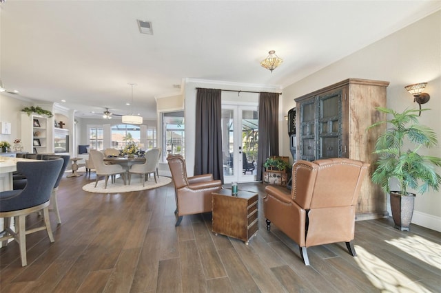 living room with dark hardwood / wood-style flooring, a wealth of natural light, ceiling fan, and french doors