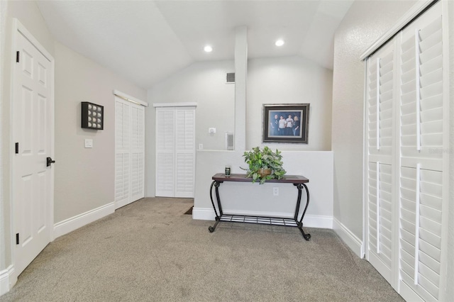 hall with visible vents, recessed lighting, baseboards, carpet, and lofted ceiling