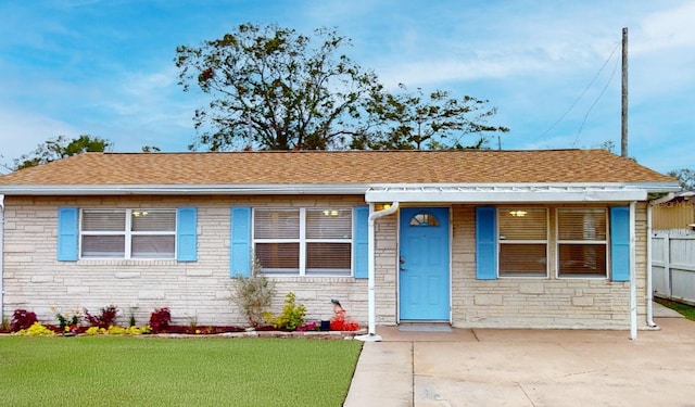 ranch-style house with a front lawn