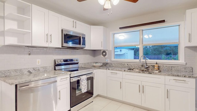 kitchen with sink, white cabinetry, backsplash, and appliances with stainless steel finishes