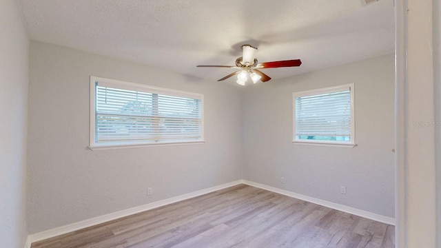 spare room featuring ceiling fan and light hardwood / wood-style floors