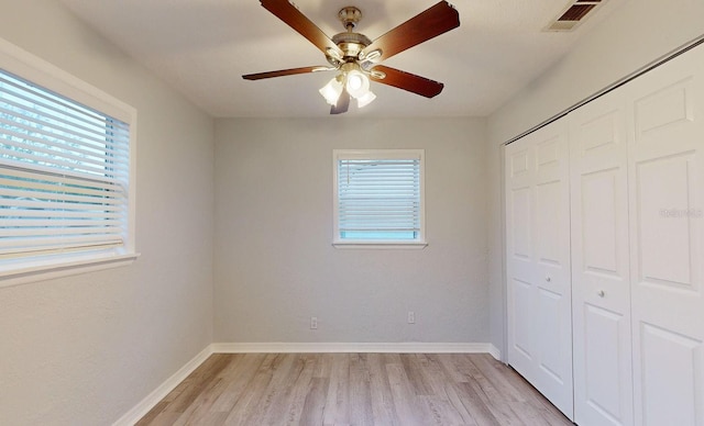 unfurnished bedroom with ceiling fan, light hardwood / wood-style floors, and a closet