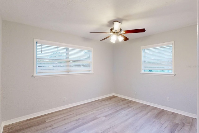 spare room featuring ceiling fan and light wood-type flooring