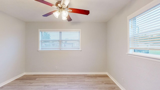 unfurnished room featuring ceiling fan, light hardwood / wood-style flooring, and a wealth of natural light