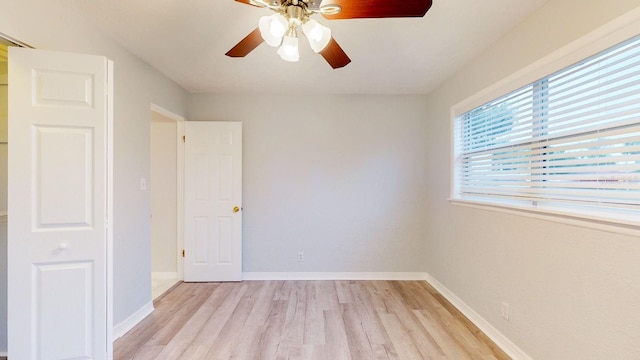 spare room with light wood-type flooring and ceiling fan